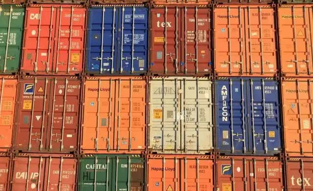 Ocean freight containers stacked at the yard, ready to load a battery order